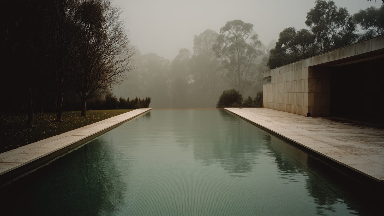 A quiet Australian pool steaming faintly on a cool, misty morning