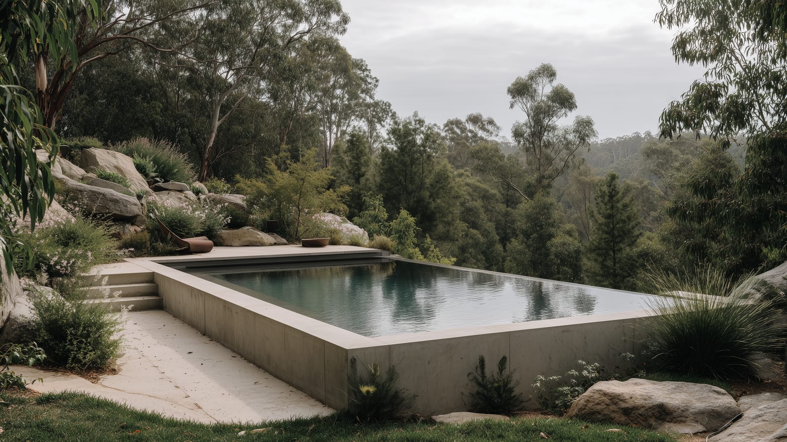 Custom concrete pool with a negative edge set into a sloping bushland site